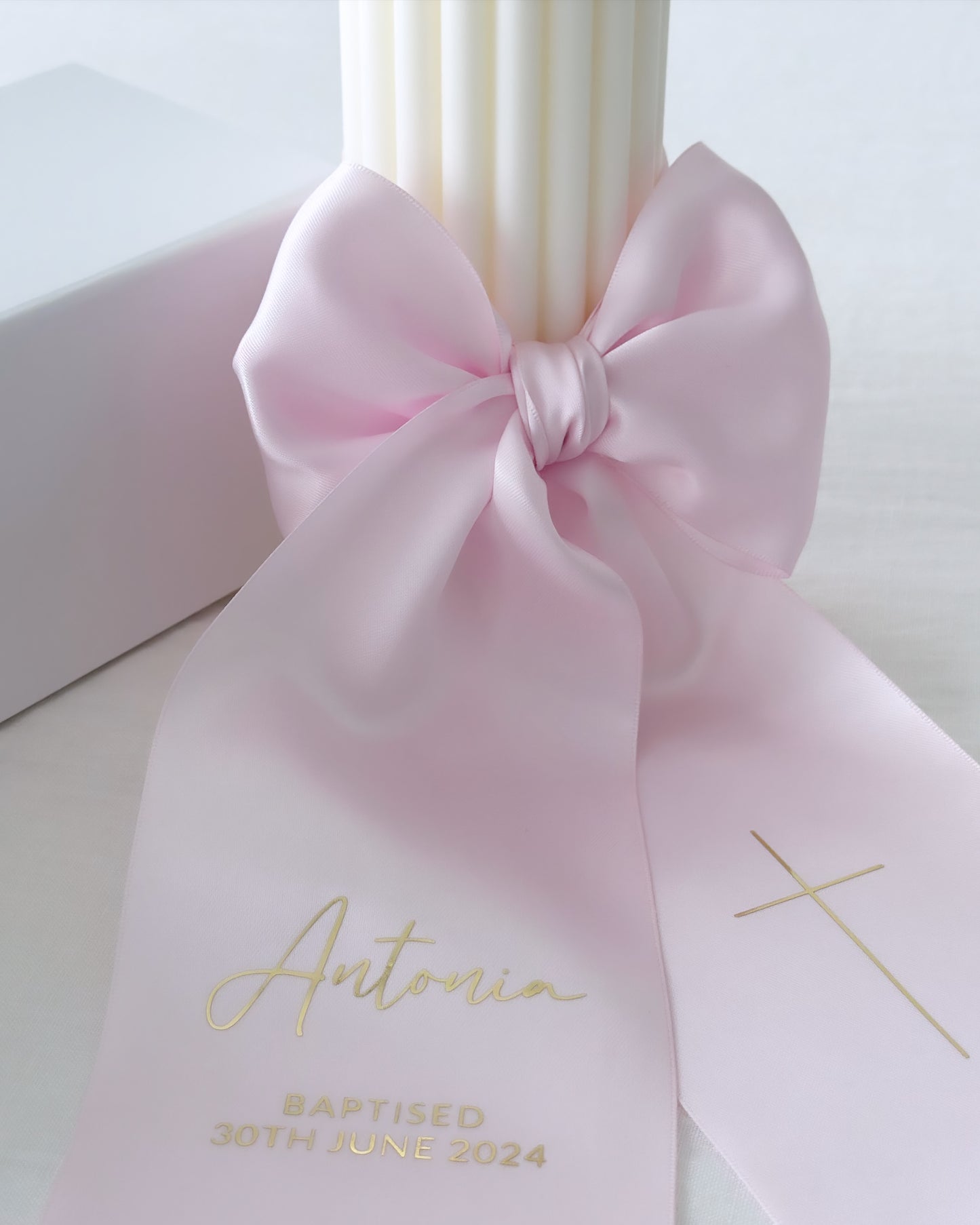 Baptism candle with text on satin bow