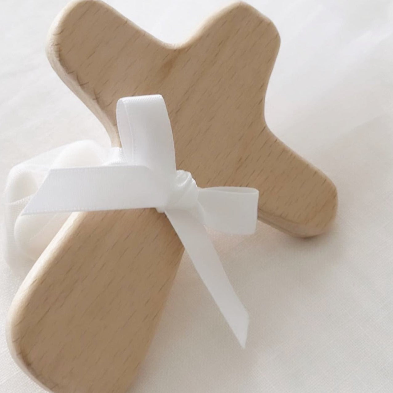 Wooden cross with 5 sugared almonds and finished in a satin bow