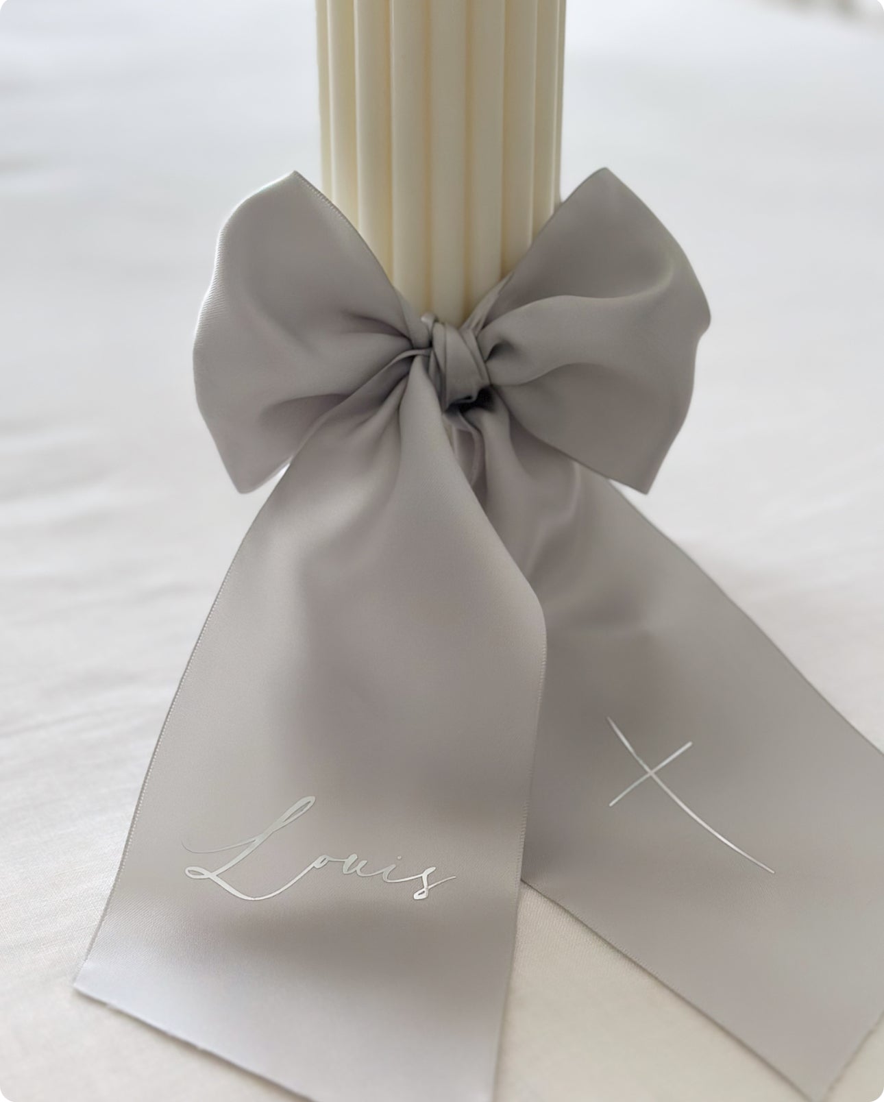 Baptism candle with text on satin bow